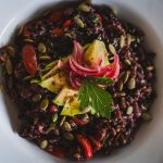 Healthy vegan black rice salad topped with avocado, pickled onions, and pumpkin seeds. — American Steakhouse in Sydney: Enjoy